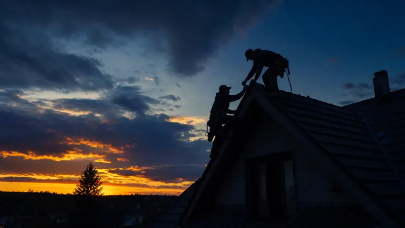 Modern home at dusk with a completed roof